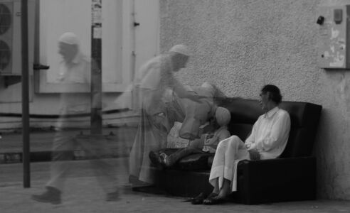 Seniors with their children at their door greeting their
neighbors and watching the street activity. Image
courtesy National Pavilion UAE – la Biennale di
Venezia.
