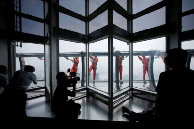 Jin Mao employee walks 340 meters above the ground around the newly opened Jin Mao tower skywalk in Shanghai. (Photo: Reuters)